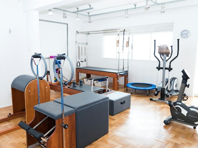 Bright modern fitness studio with wooden floors and plants